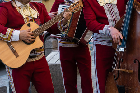 Mexican musician mariachi plays the guitar on a city street.の写真素材