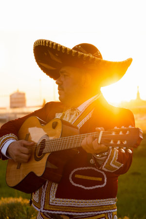 Mexican musician mariachi plays the guitar on a city street.の写真素材