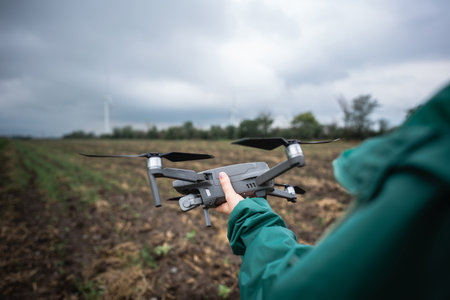 Farmer with drone on a field. Smart farming and precision agriculture..