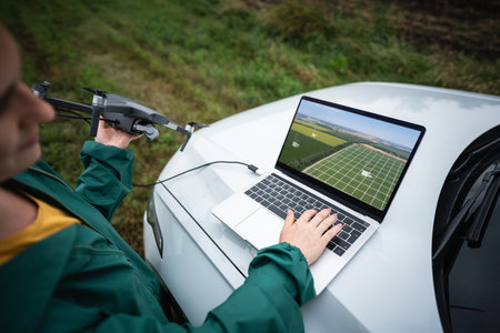A woman with a laptop and drone.