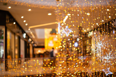 Blurred holiday background with bokeh. Defocused New Year and Christmas illuminationの写真素材