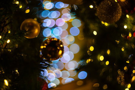 Blurred holiday background with bokeh. Defocused New Year and Christmas illuminationの写真素材