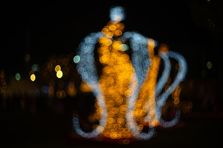 Blurred holiday background with bokeh. Defocused New Year and Christmas illumination.