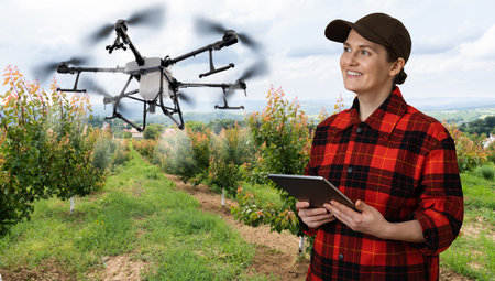 Drone sprayer flies over apple trees. Smart farming and precision agriculture.