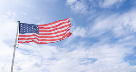 American flag waving in wind. Symbol of the United States of America..
