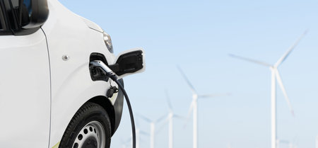 Charging electric van and wind turbines in a background