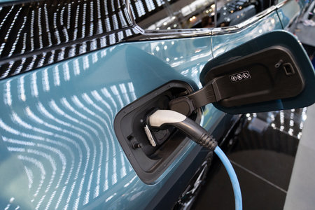 Close up of electric car inlet with a connected charging cable.の写真素材