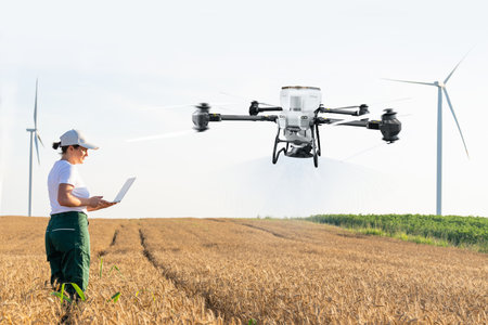 Woman farmer with drone on a wheat field. Smart farming and precision agriculture..