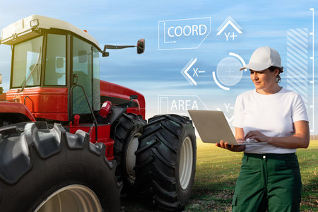 Female farmer with laptop controls an autonomous tractor on a smart farm..