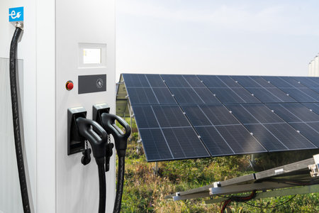Close up of electric car charging station on the background of solar panels..の写真素材