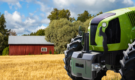 Green tractor on a agricultural field.の写真素材