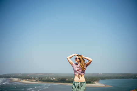 Young sexy girl relaxed near sea at summer holiday nice hot day,casual wear,enjoy,happy woman,relaxing,traveling,attractive,style,modelの写真素材