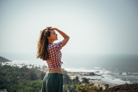 Young sexy girl relaxed near sea at summer holiday nice hot day,casual wear,enjoy,happy woman,relaxing,traveling,attractive,style,modelの写真素材