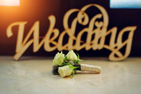 Bridal bouquet with white roses close-up. Wedding bouquet on the background of the inscription, blurred text.の写真素材