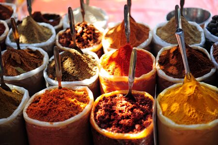 Variety of spices on the market in Asia. Powdered spices in bags, close-up. Turmeric, chili pepper, coriander, nutmeg, spices in eastern bazaar.の写真素材