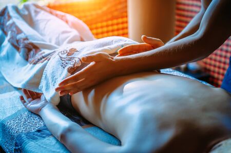 Man masseur. Hands massaging female back close up. People, beauty, healthy lifestyle and relaxation...