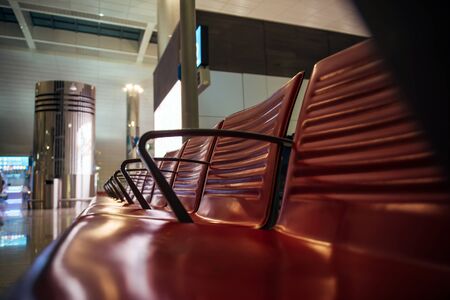 Rows of seats at the airport, close-up. Seats in the waiting room at the station, selective focus. Modern airport, futuristic design.の写真素材