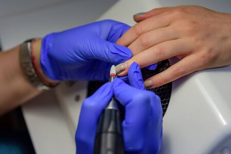 Process of cleaning the nail from old coating, preparing before applying nail polish. Manicure...