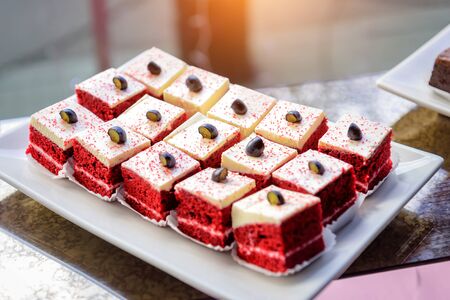 Portion cakes with cream. Dessert red velvet, close-up. Sweets at festive banquet.の写真素材