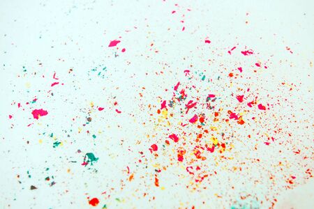 Multi-colored powder paint spread over white background. Holi concept.