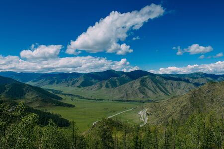 Spectacular landscape overlooking the green valley in the mountains. Journey in the mountains of Altai. Sunny summer day.の写真素材