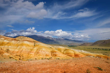 Amazing natural phenomenon-Martian landscapes in the Altai mountains. Multicolored rocks against a blue sky with white clouds. Futuristic panoramic picture, background image. Mars.の写真素材