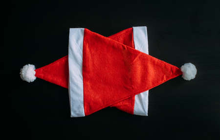 Santa Claus hats on top of each other. Pentagonal star making from Santa Claus hats. New year's concept, Christmas background.の写真素材
