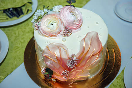Beautifully decorated handmade cake. Exquisite sweets at festive banquet. Dessert table, close-up.の写真素材