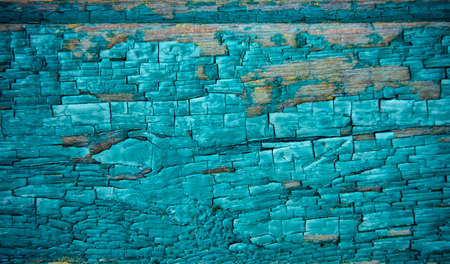 Old wooden background, peeling blue paint. Shabby horizontal board, dilapidated texture, close-up.の写真素材