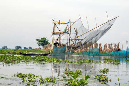 north 24 pargana west bengal india on september 3rd 2021:Rural West Bengal Unique style fishing net. There are bamboo structures with nets and scaffolding barriers.のeditorial素材