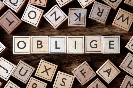 the word of OBLIGE on blocks building conceptの写真素材