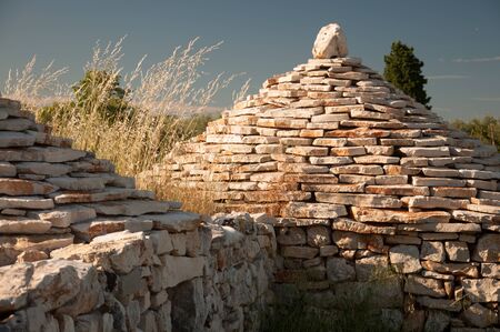 Close up of two traditional istrian huts - Kazun. With blue sky in background.の写真素材