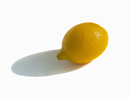 Yellow ripe lemon isolated on a white background with the shadow.の写真素材
