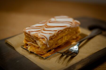 Close-up of the fresh puff pastry cake on a wooden board.の写真素材