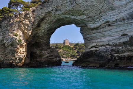 Mediterranean sea coast landscape, blue clear sky and sea, with an opening in the rock.の写真素材