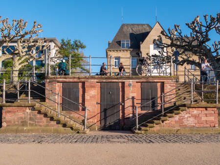 Frankfurt am Main, Germany, April 11, 2020: Two persons talking to each other on a distance during COVID 19 outbreak.のeditorial素材