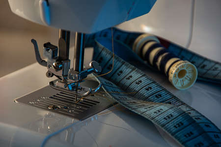 Sewing machine with colorful fabrics and other sewing accessories.の写真素材