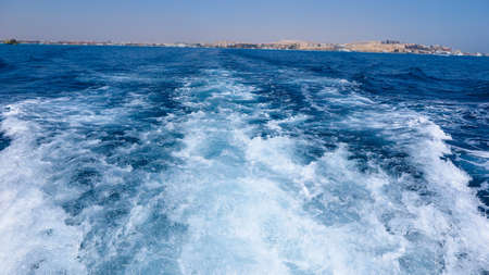 The Red Sea is blue transparent with white foam from the boat .Vacationの写真素材