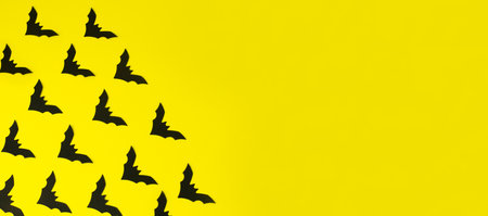 Poster with bats on yellow background with copy space, empty for text.の写真素材