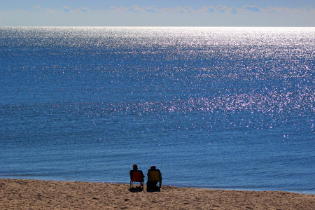 Happy Romantic Couple Enjoying Beautiful Sunset at the Beachの写真素材