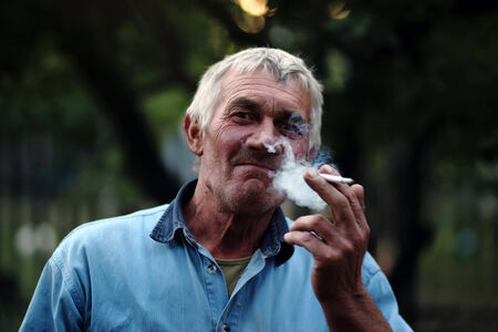 Man with cigar, smoking kills  in smokeの写真素材