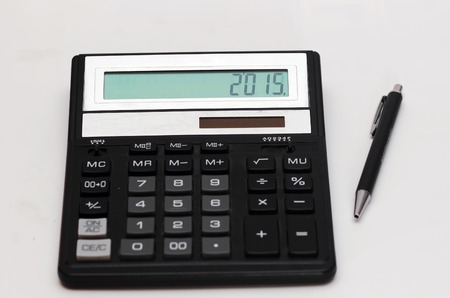 Calculator and pen isolated on white backgroundの写真素材