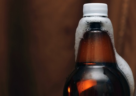 plastic  Bottle of beer with vials, foam and a plastic coverの写真素材