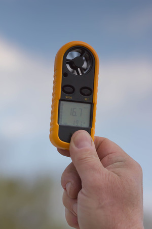 Anemometer in the hand of man, which measures wind speedの写真素材