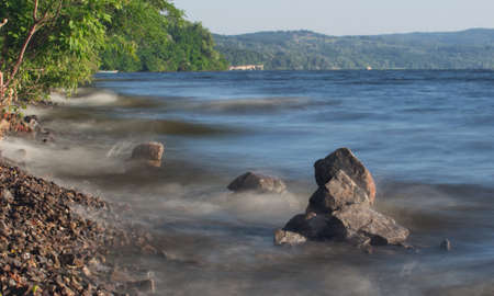 Stones in the water by wave actionの写真素材