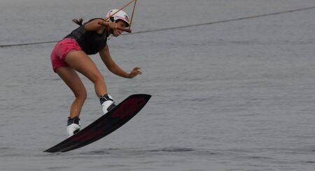 Lazurnoe , Ukraine, August 23, 2015:  Festival of music and sports Crayzy Day , Wakeboarder making tricks on sunsetのeditorial素材