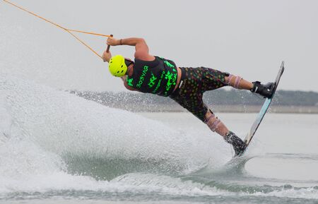 Lazurnoe , Ukraine, August 23, 2015:  Festival of music and sports Crayzy Day , Wakeboarder making tricks on sunsetのeditorial素材