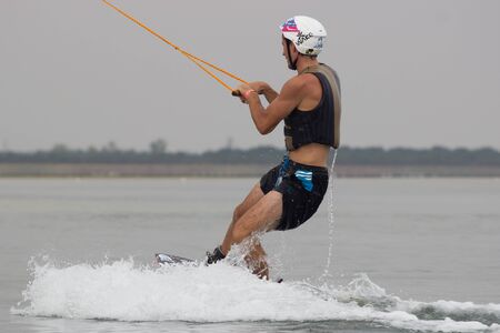 Lazurnoe , Ukraine, August 23, 2015:  Festival of music and sports Crayzy Day , Wakeboarder making tricks on sunsetのeditorial素材