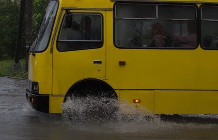 CHERKASSY, UKRAINE- JUNE 27, 2015: cars driving on a flooded road during a flood caused by heavy rain, in Cherkassy.のeditorial素材