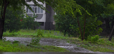 CHERKASSY, UKRAINE- JUNE 27, 2015: cars driving on a flooded road during a flood caused by heavy rain, in Cherkassy.のeditorial素材